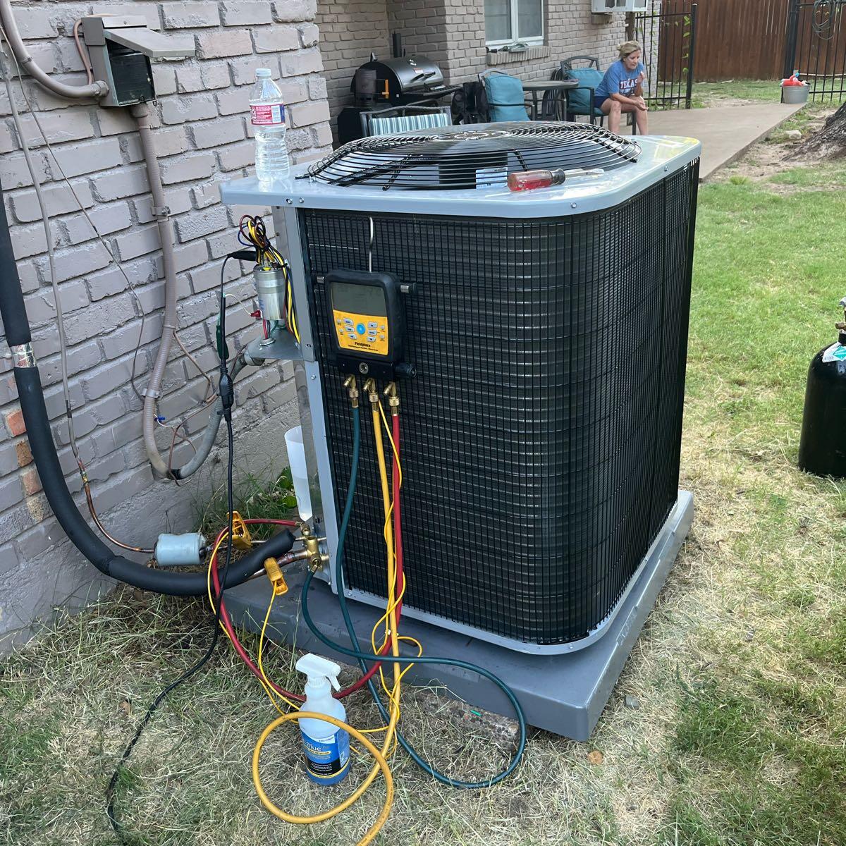 hvac repair image2 Affordable Comfort Heating and Cooling technician repairing HVAC system in Dearborn, MI