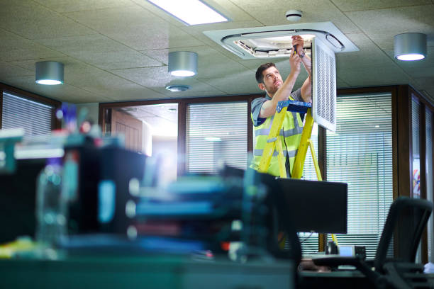 HVAC technician servicing residential heating and cooling equipment in Flat Rock, Michigan